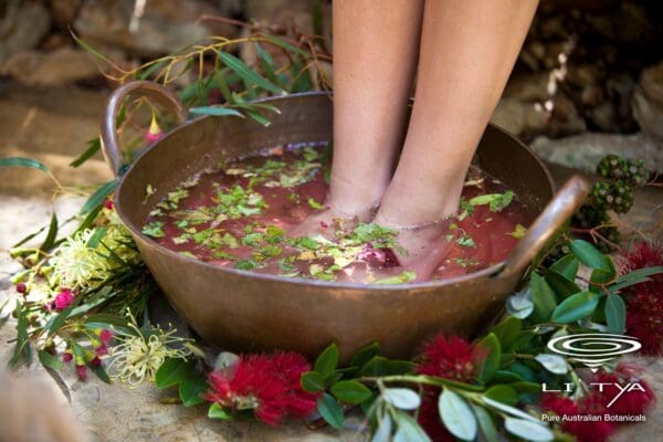 A person standing in a bowl of water with food.