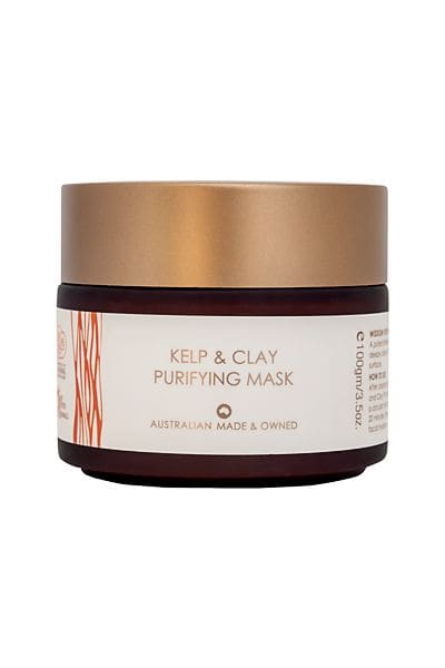 A jar of face mask with gold label.