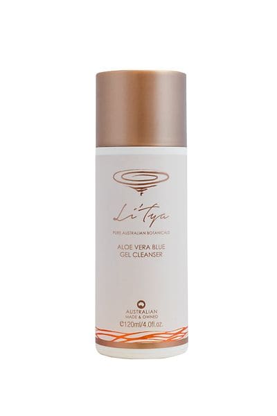 A bottle of skin care product with a gold lid.