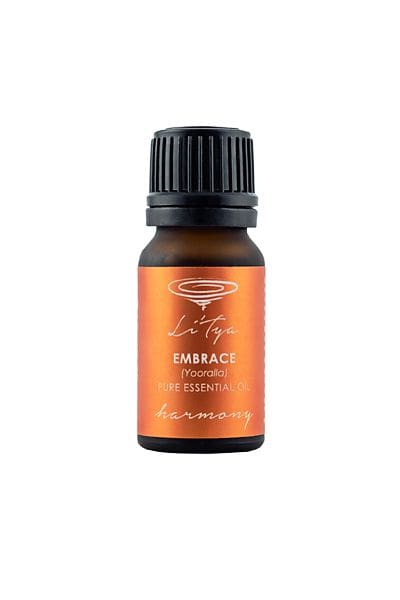 A bottle of essential oil with the word embrace written on it.